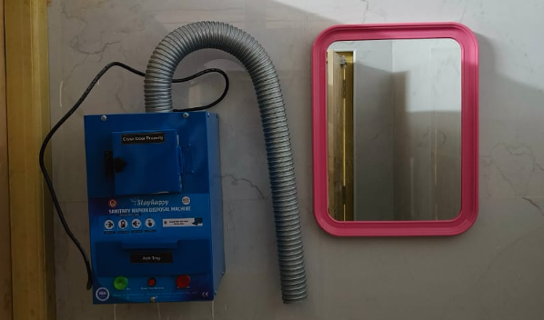 Napkin vending machine and incinerator